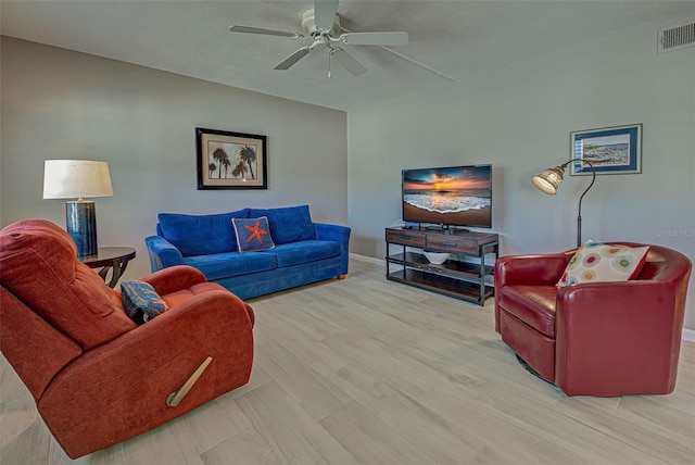 living room with light hardwood / wood-style flooring and ceiling fan