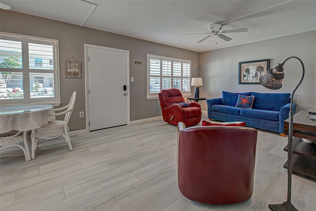 living room with ceiling fan and light hardwood / wood-style floors