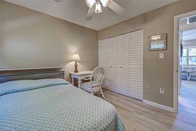 bedroom with ceiling fan, a closet, and light hardwood / wood-style floors