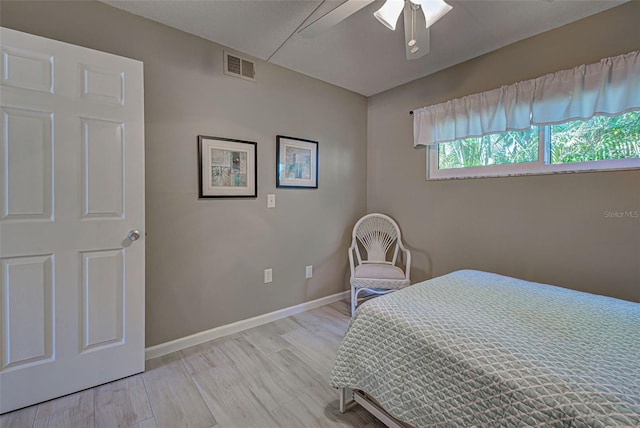 bedroom with ceiling fan and light wood-type flooring