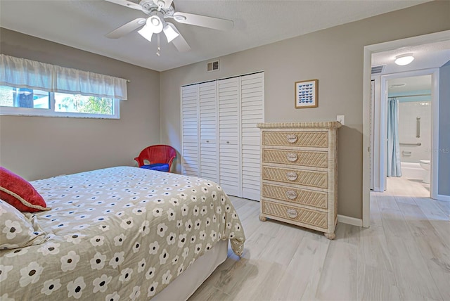 bedroom with ceiling fan, a closet, and light hardwood / wood-style floors