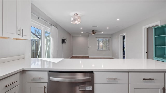 kitchen with stainless steel dishwasher, ceiling fan, white cabinetry, and kitchen peninsula