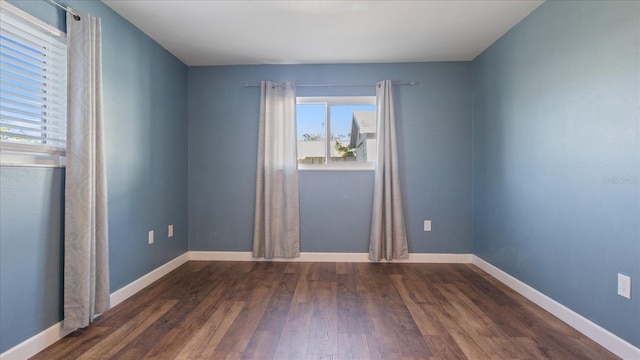 spare room with dark hardwood / wood-style floors