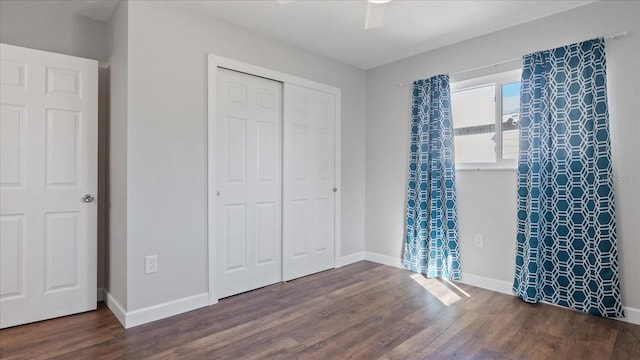 unfurnished bedroom with a closet, ceiling fan, and dark wood-type flooring