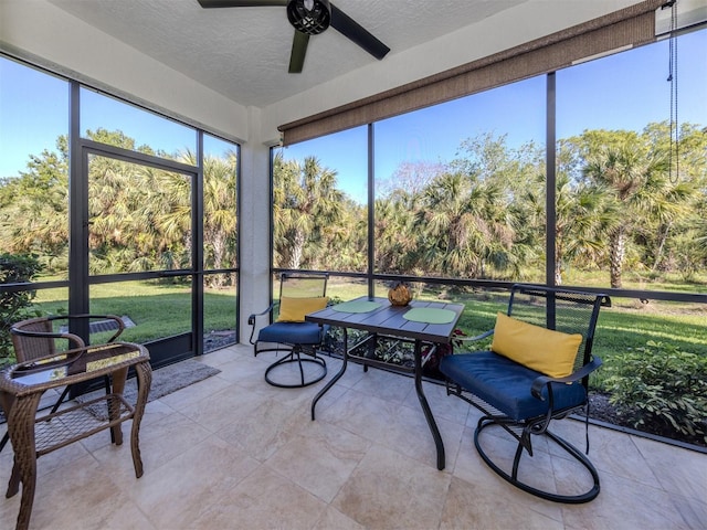 sunroom / solarium featuring ceiling fan