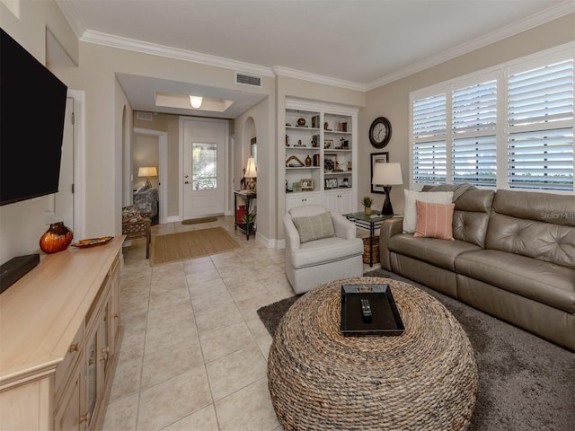 living room featuring built in features, crown molding, and light tile patterned floors