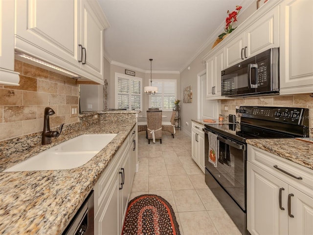 kitchen with black appliances, white cabinets, light tile patterned floors, and sink