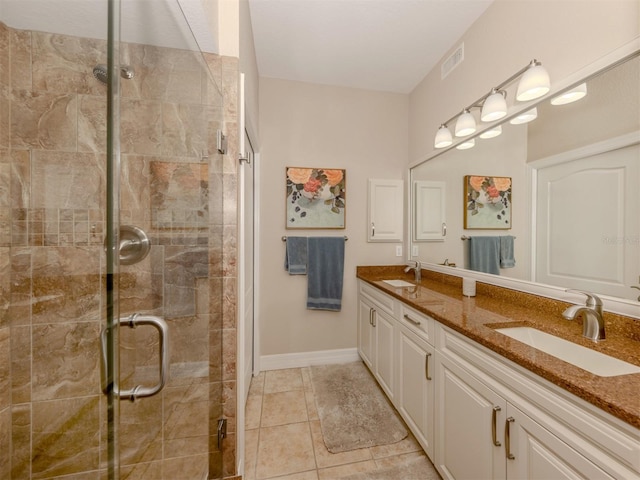 bathroom featuring vanity, tile patterned floors, and a shower with door