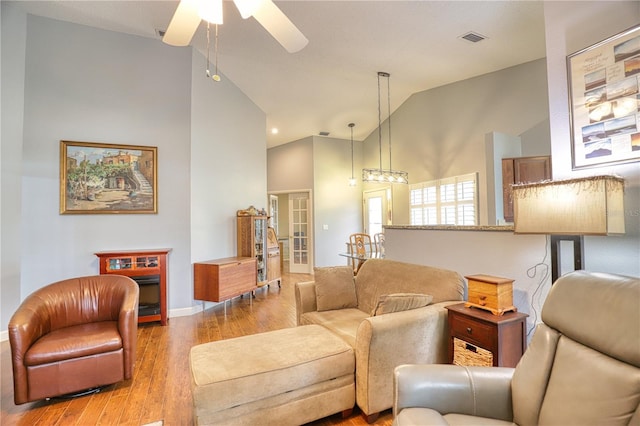 living room with high vaulted ceiling, light hardwood / wood-style flooring, and ceiling fan