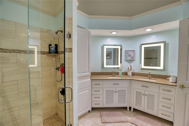 bathroom with vanity, tile patterned floors, a shower with door, and ornamental molding