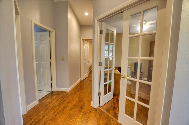 hall featuring hardwood / wood-style floors and french doors