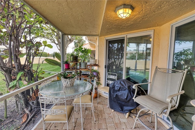 view of patio / terrace with a grill and a balcony