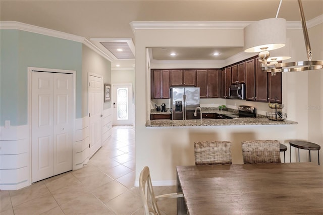 kitchen with kitchen peninsula, pendant lighting, stone countertops, light tile patterned floors, and appliances with stainless steel finishes