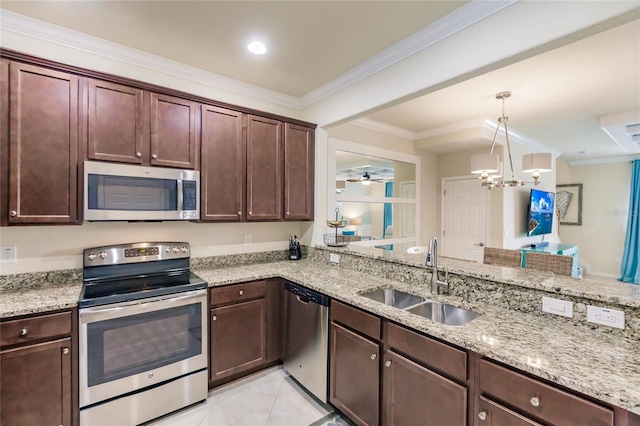 kitchen featuring sink, hanging light fixtures, stainless steel appliances, kitchen peninsula, and ornamental molding