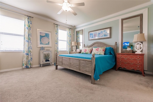 carpeted bedroom featuring ceiling fan and crown molding