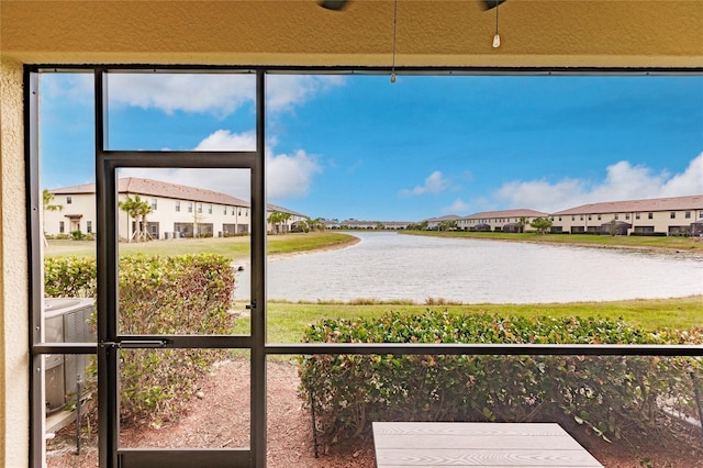 unfurnished sunroom with a water view