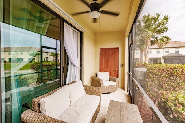 sunroom featuring ceiling fan and a healthy amount of sunlight