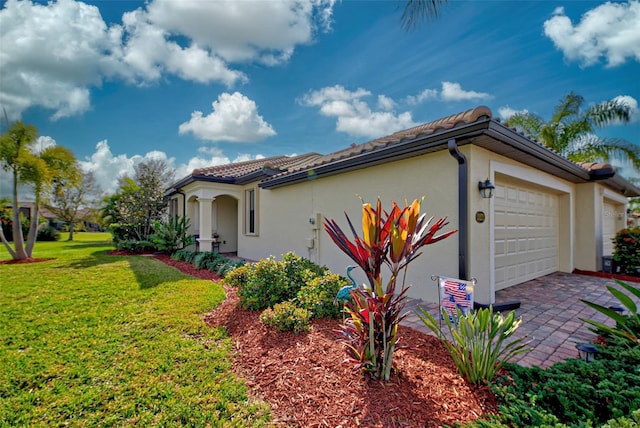 view of side of home with a yard and a garage