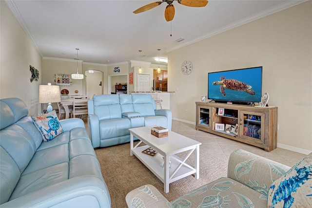 living room featuring ceiling fan, light tile patterned floors, and crown molding