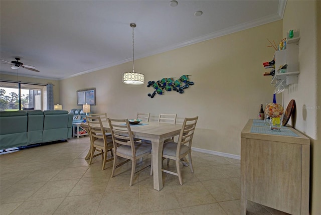 tiled dining room featuring ceiling fan and ornamental molding