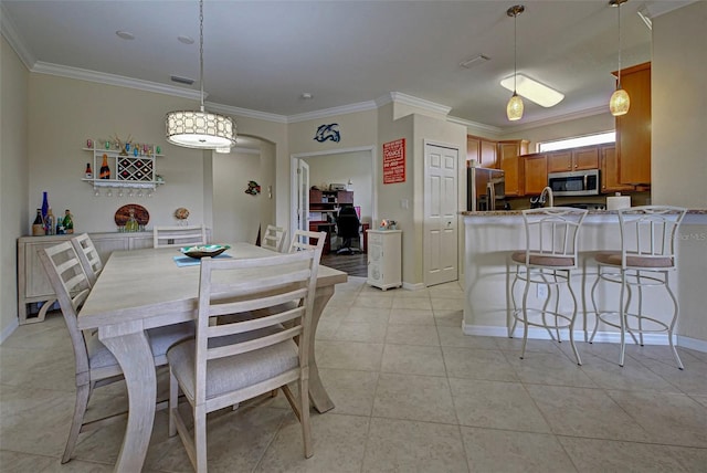 dining space with light tile patterned flooring and crown molding