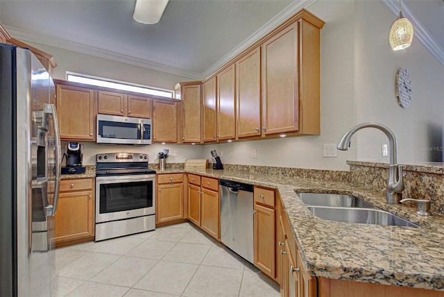 kitchen featuring appliances with stainless steel finishes, light stone counters, ornamental molding, and sink