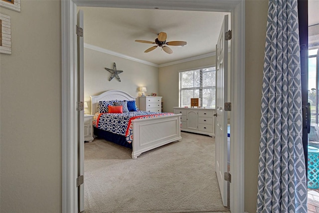 bedroom with light carpet, ceiling fan, and crown molding