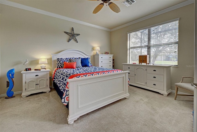 carpeted bedroom featuring ceiling fan and crown molding