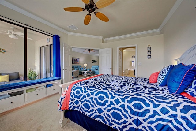 carpeted bedroom with ceiling fan and ornamental molding