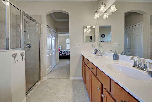 bathroom with walk in shower, tile patterned floors, vanity, and ornamental molding