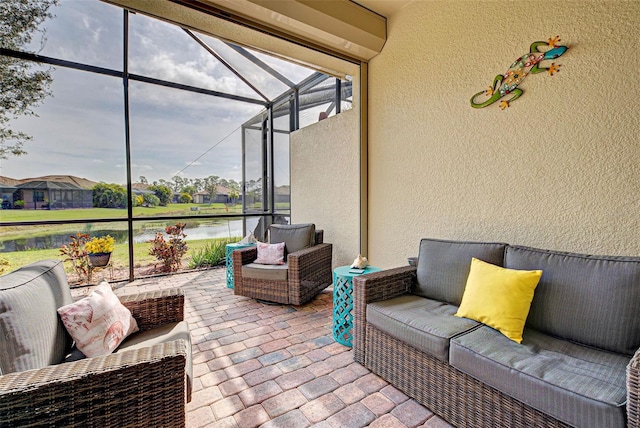 view of patio / terrace featuring a lanai and a water view