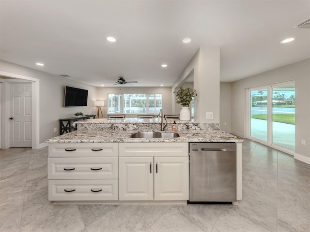 kitchen with ceiling fan, dishwasher, light stone countertops, sink, and white cabinets