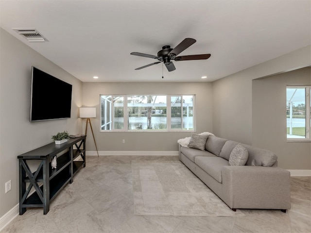 living room featuring a water view and ceiling fan