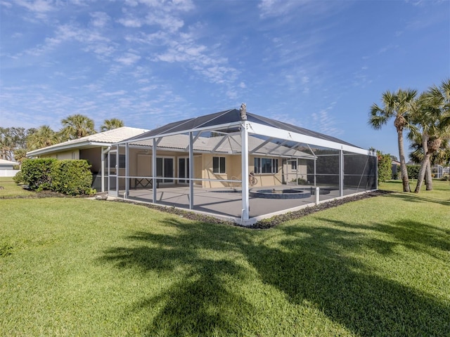 back of house with a pool, a lawn, a lanai, and a patio area