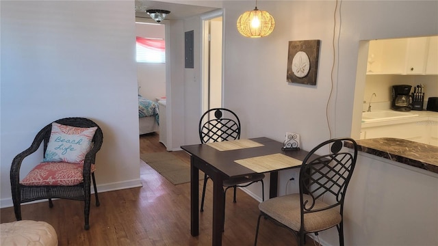 dining room with dark hardwood / wood-style flooring and sink