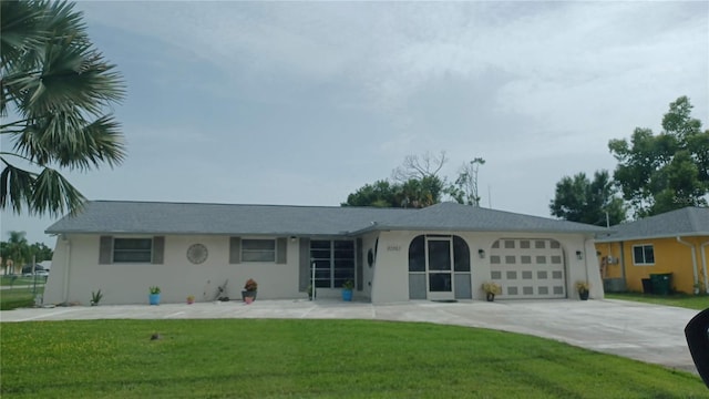 ranch-style home featuring a front lawn and a garage