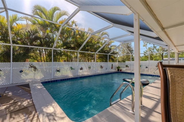 view of pool featuring glass enclosure