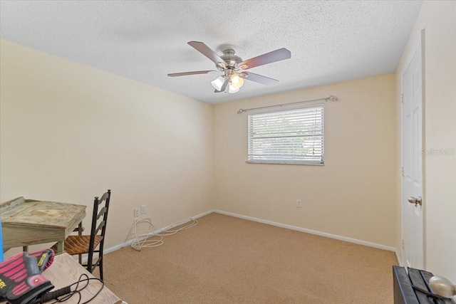 carpeted office with ceiling fan and a textured ceiling