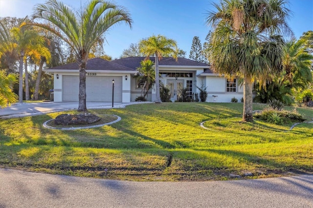 ranch-style house featuring a front lawn and a garage