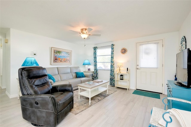 living room featuring ceiling fan and light hardwood / wood-style flooring