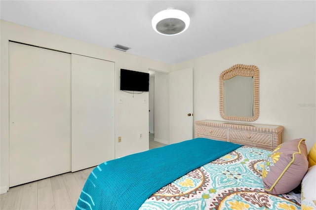 bedroom featuring a closet and light wood-type flooring