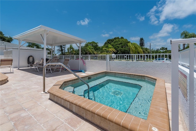 view of swimming pool featuring an in ground hot tub and a patio