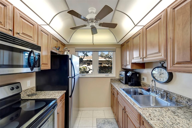 kitchen with sink, ceiling fan, black / electric stove, light tile patterned flooring, and light stone counters