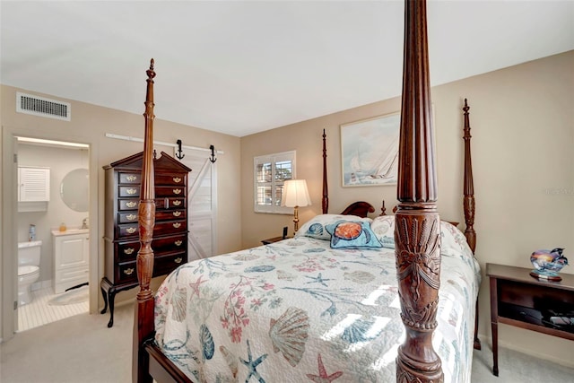 carpeted bedroom featuring ensuite bathroom