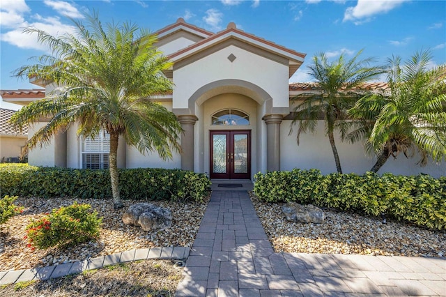 view of exterior entry featuring french doors