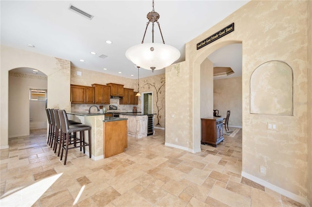 kitchen with a breakfast bar and hanging light fixtures