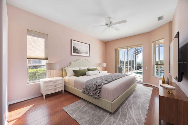 bedroom with ceiling fan, dark wood-type flooring, and access to outside