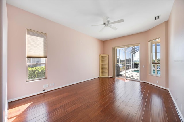 empty room featuring ceiling fan and dark hardwood / wood-style floors