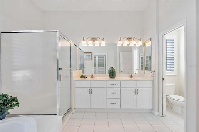 bathroom featuring tile patterned floors, toilet, an enclosed shower, and vanity