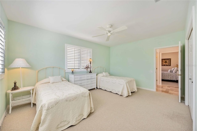 carpeted bedroom with ceiling fan and a closet